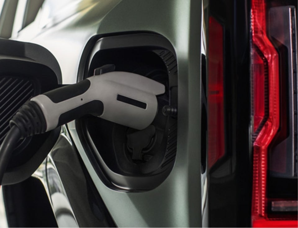 Close up of charging port with charger plugged in on a GMC Hummer EV SUV - Morgan GMC Bossier in Bossier City LA